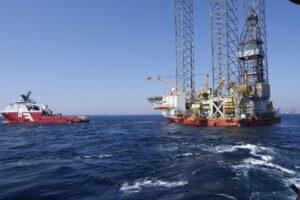 oil rig being towed at sea
